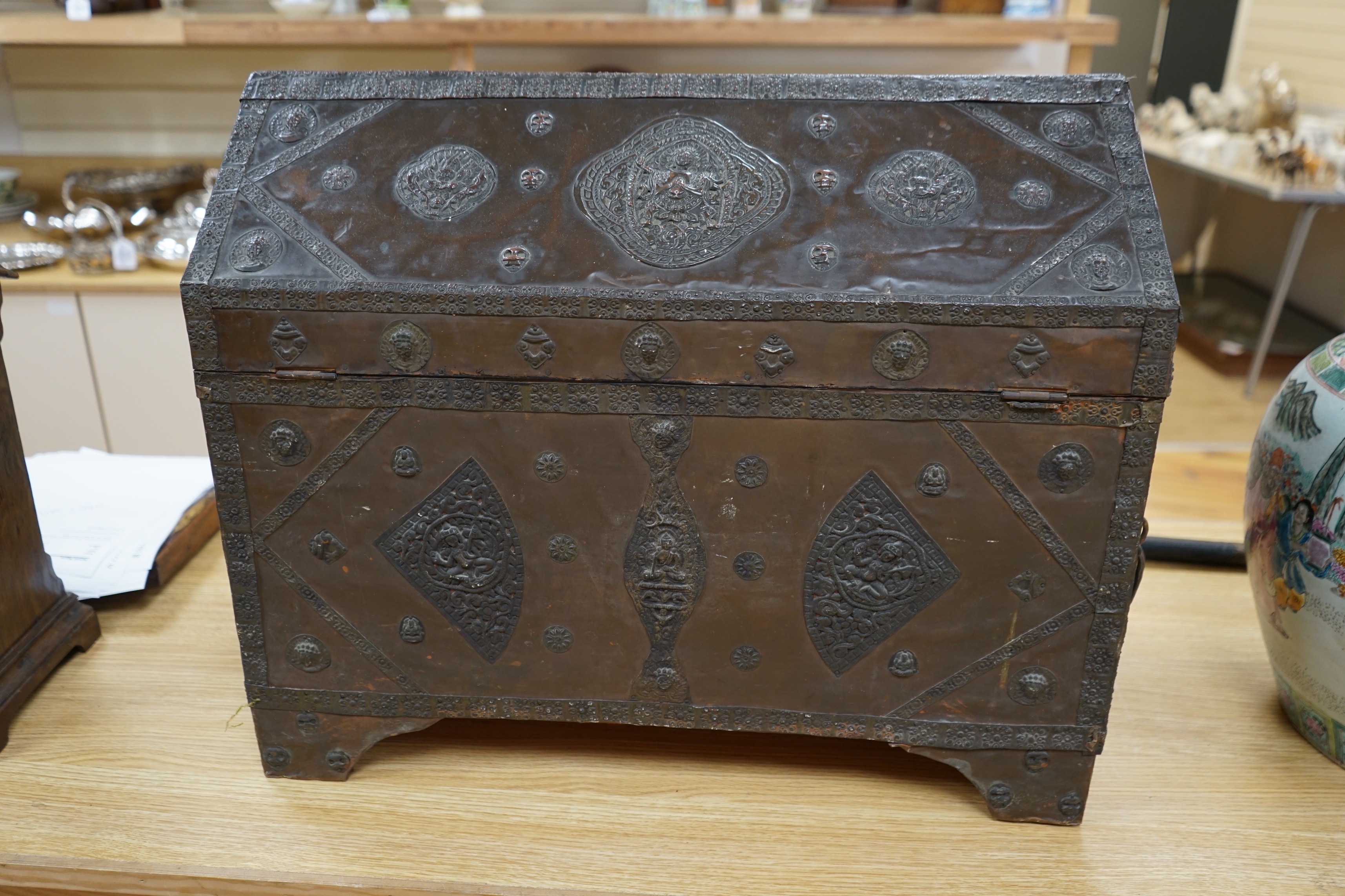 A Tibetan copper repousse-work casket, 20th century, 65cm wide, 49.5cm